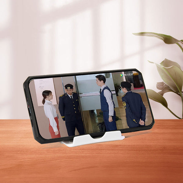 A plastic, foldable cradle for mobile phones